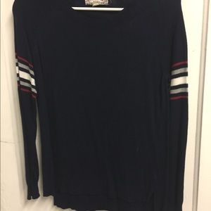 Navy sweater with striped detailed sleeves.